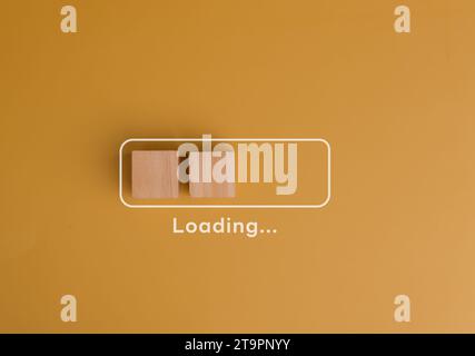 Wooden cube blocks with loading bar progress concept. Business idea progress plan strategy concept on yellow background. Stock Photo