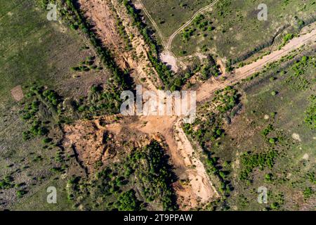 Aerial view of a cross-shaped exploration sand pit in a field Stock Photo