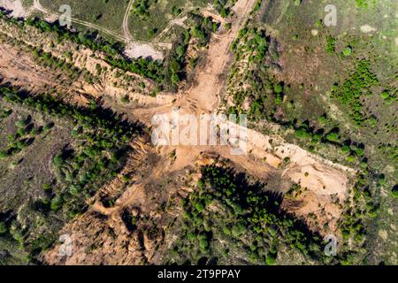 Aerial view of a cross-shaped exploration sand pit in a field Stock Photo