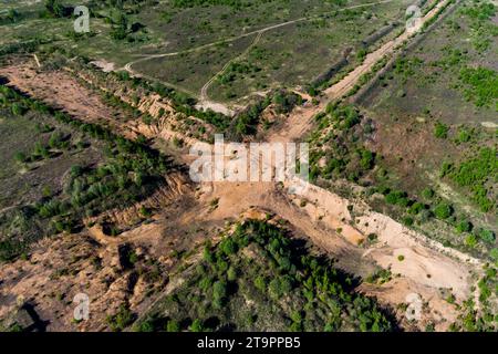 Aerial view of a cross-shaped exploration sand pit in a field Stock Photo