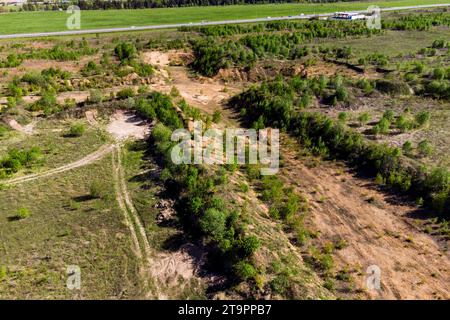 Soil in the field removed to layers of sand for exploration of a future quarry Stock Photo