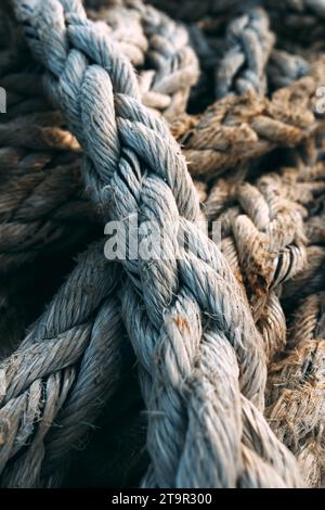 Old worn frayed ship ropes as background, selective focus Stock Photo