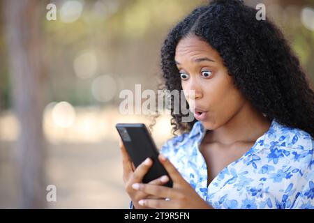 Phone, surprise and shock of black woman in studio isolated on a yellow  background. Wow, cellphone and surprised African female with smartphone for  Stock Photo - Alamy