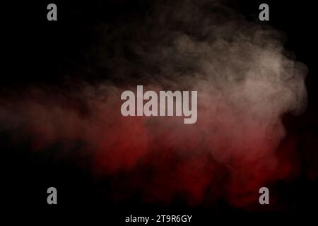 Orange and red steam on a black background. Copy space. Stock Photo