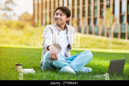 Happy asian guy student chilling at university campus Stock Photo