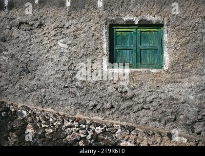 Antique old weathered dark green wooden window with two closed shutters of old house. Facade detail, doors and windows. El Pinar of El Hierro Island. Stock Photo