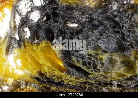 Texture of homemade slice of sourdough freshly baked bread on white background, activated carbon, pumpkin and curcuma spice Stock Photo