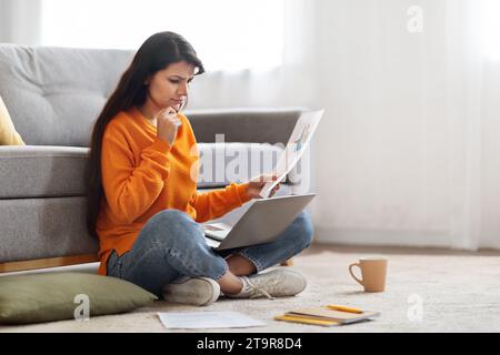 Upset young indian woman working from home, using laptop Stock Photo