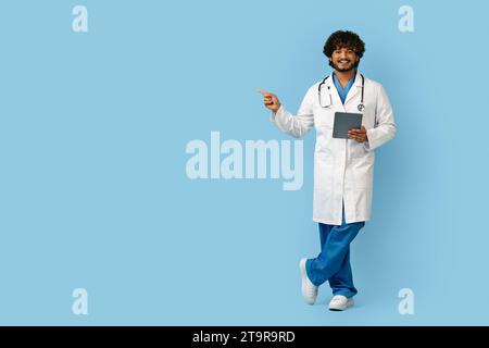 Smiling Confident Indian Doctor Using Digital Tablet Stock Photo