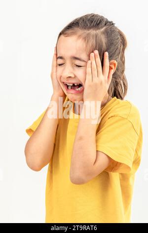 Little desperate girl looking panic, holding her head with both hands Stock Photo - Alamy