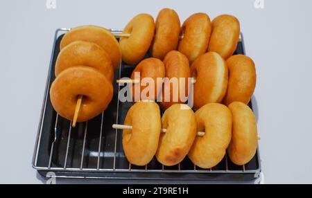 a bunch of freshly baked donuts. Usually served with or without powdered sugar Stock Photo