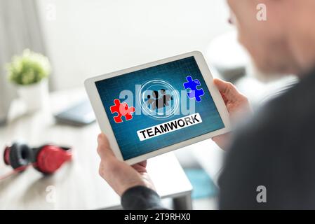 Tablet screen displaying a teamwork concept Stock Photo