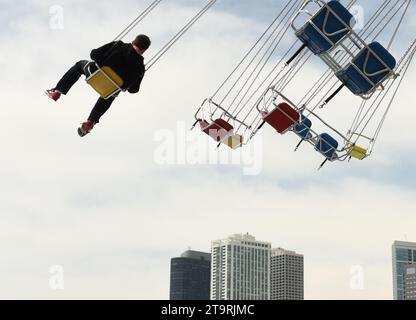 Chicago, Illinois, USA - June 06, 2018: People ride the Wave Swinger on Navy Pier in Chicago. Stock Photo