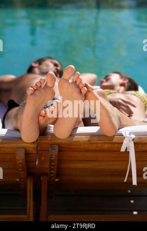 A couple lying by the pool in Uruguay. Stock Photo