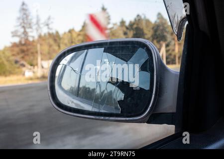 Broken rearview mirror. Crack on the glass of the vehicle. Stock Photo