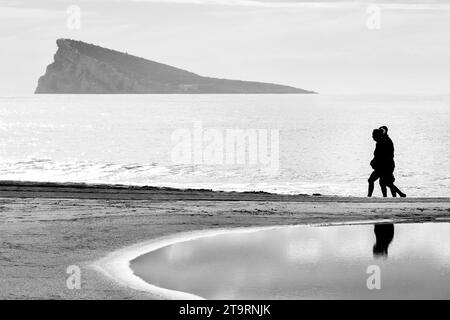A couple walking on the beach in Benidorm Stock Photo
