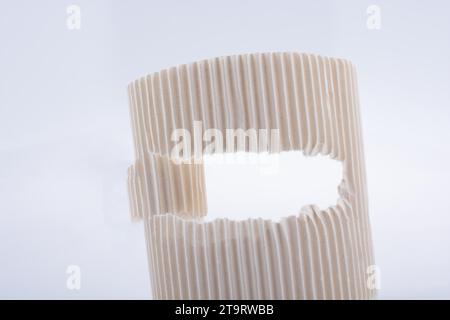 Rolled up torn paper on a white background Stock Photo