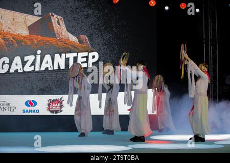 November 23, 2023: Gaziantep, Turkiye, 23 November 2023. Traditional folkloric dancing is performed during the official opening of the â€œSecond Gazi Gamesâ€ in the southern Turkish city of Gaziantep. The ceremony was attended by the Turkish Minister of Youths and Sports Osman AÅŸkÄ±n Bak, in addition to local politicians and dignitaries. The Gazi Games have been organized in coordination with the Gaziantep Governorate and the Greater Gaziantep Municipality, as well as with the Directorate of Youth and Sports and the Directorate of National Education of the governorate (Credit Image: © Muhamm Stock Photo