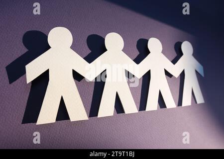 Teamwork and relations concept. symbolic of paper chains. People are connected to each other. Concept of human role. The concept of teamwork. Stock Photo