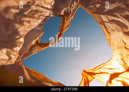 Inside of used plastic bags floating in the air and sky, garbage and pollution, global warming and climate change. Stock Photo