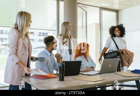 Businesswoman smiling while entering the office to work. Business concept. Stock Photo