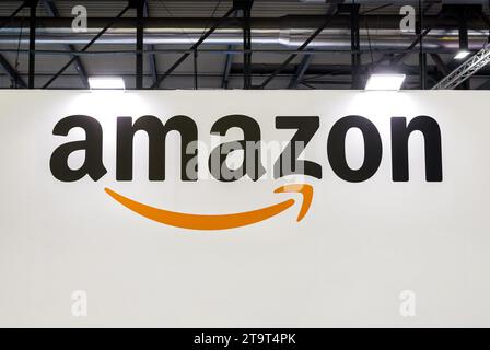 From below of Amazon logo on screen at illuminated convention and exhibition center Stock Photo