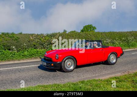 1978 70s seventies Red MG Midget, 3947 cc. Round arch British Petrol sports cabrio car; Vintage, restored classic motors, automobile collectors motoring enthusiasts, historic veteran cars travelling in Cheshire, UK Stock Photo