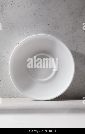 One white ceramic saucer on the table with an abstract pattern Stock Photo