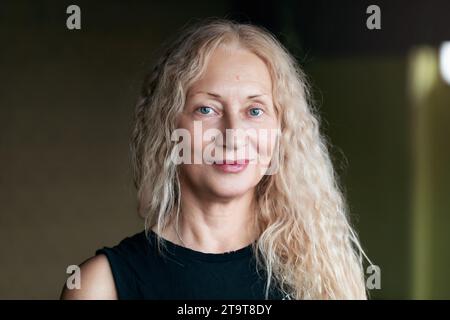 Portrait of a satisfied middle-aged blonde woman looking at the camera Stock Photo