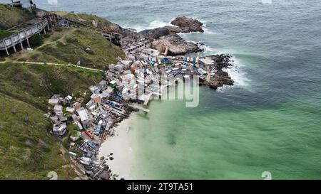 Fishing port and wharf in Arraial do Cabo. Construction of storage rooms and scaffolding to hold boats and fishing equipment perched on the cliff Stock Photo