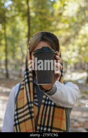 Two paper coffee cups on a paper tray, with biscuits on the side, wooden stump. Stock Photo