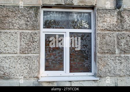 Newly installed window with a brick wall behind it Stock Photo