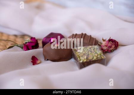 Chocolate Pieces with Elegant Flowers and Roses on Pink and White Background. Romantic Concept with Mock-Up Space for Customization. Ideas for Valenti Stock Photo