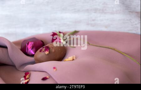 Chocolate Pieces with Elegant Flowers and Roses on Pink and White Background. Romantic Concept with Mock-Up Space for Customization. Ideas for Valenti Stock Photo