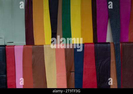 A variety of colorful leather belts and sashes on a display rack in an outdoor market in Florence, Italy. Stock Photo