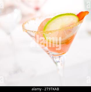 glass of caipiroska with ice cream, strawberry and lime slice on wedding table; glass of caipiroska with ice cream, strawberry and lime slice on wedding table Stock Photo