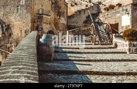 old historical scene with wood wagon and wine barrels typical tool used in the past, old style, in Matera, Italy UNESCO European Capital of Culture 2019 Stock Photo