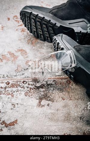 Workwear for craftsman - safety footwear and goggles Stock Photo