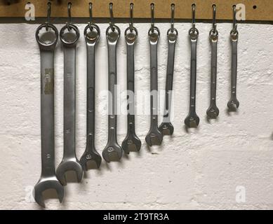 General view of a set spanners hanging on the wall Stock Photo