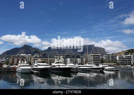 A General view of luxury yachts moored with white fluffy clouds partially covering the beautiful Table Mountain in Cape Town, South Africa Stock Photo