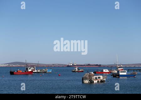 Old fishing trawlers anchored in Saldanha Bay on the West Coast of South Africa Stock Photo