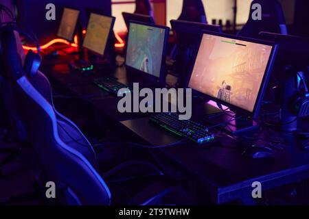 Background image of professional gaming setup in cybersports club interior with video game playing on screen, copy space Stock Photo