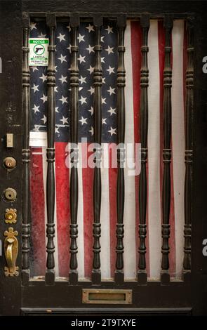 notice guns are allowed in this house sign and American flag hanging in window in Savannah Georgia Stock Photo