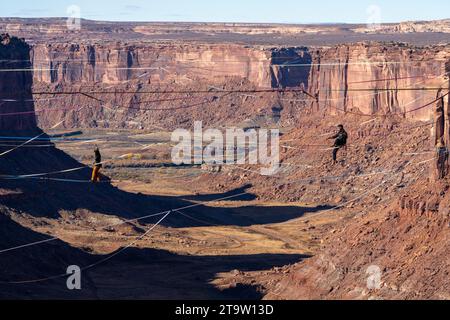 Two men walking on highlines at the GGBY World Highline Festival 500 feet above Mineral Canyon near Moab, Utah. Stock Photo