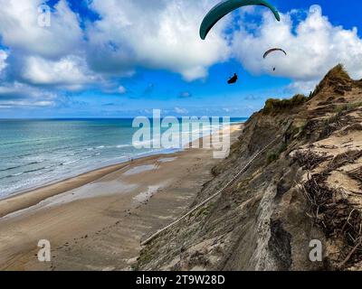 Paraglider in morning light over the cliff coast at Lyngby in Jutland, Denmark. Stock Photo