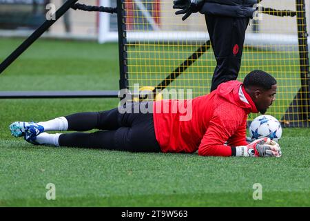 Carnago, Italy. 27th Nov, 2023. Mike Maignan of AC Milan warms up during the AC Milan training session at Milanello Sports Center ahead of their UEFA Champions League 2023/24 Group Stage F match against Borussia Dortmund at Centro Sportivo Milanello, Carnago. Credit: SOPA Images Limited/Alamy Live News Stock Photo