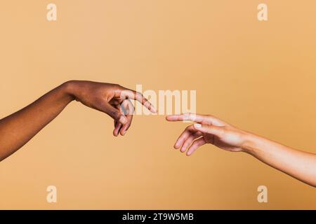Close up of two female hands together on brown background. Hands of two african american women. Stock Photo