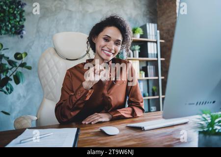 Portrait of positive gorgeous attorney lady sit leather chair arm hold eyeglasses loft interior office room inside Stock Photo