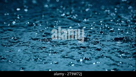 slow motion heavy rain water drops on surface street Stock Photo