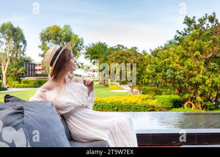 A modern woman enjoys a peaceful moment amidst nature splendor Stock Photo